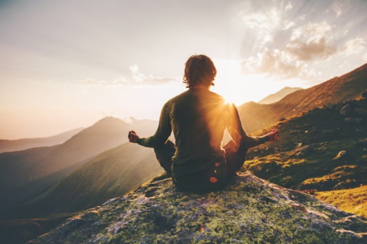 Person sitting on a mountain top