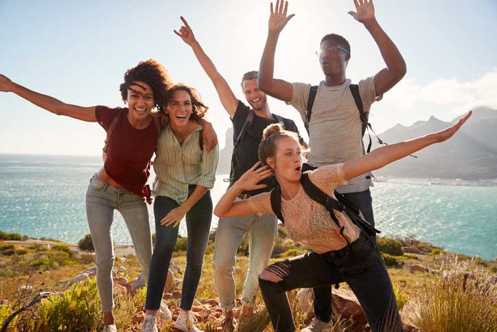 Happy group outside near the ocean