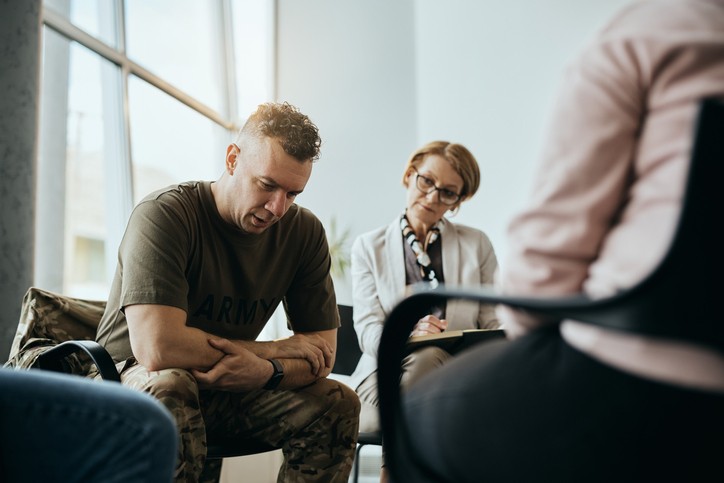 Sitting man talking to group