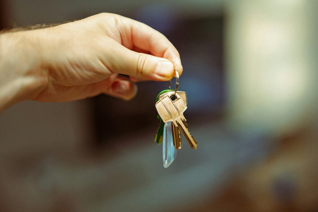 Person holding house keys after moving into San Diego sober living aftercare home