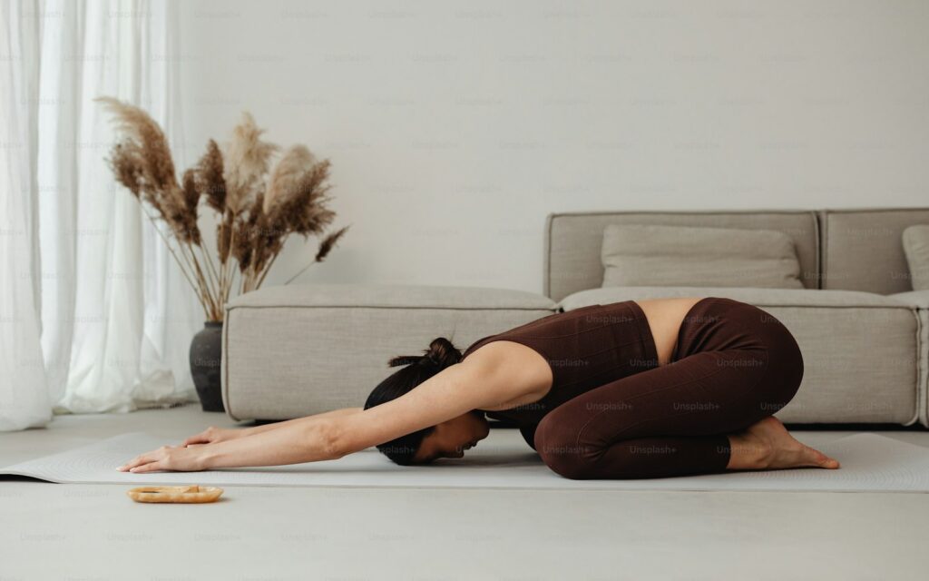 a woman is doing a yoga pose on the floor
