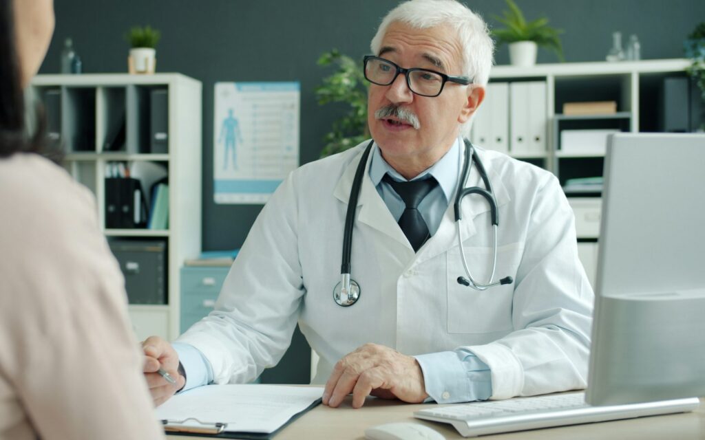 Doctor talking to patient in an office.