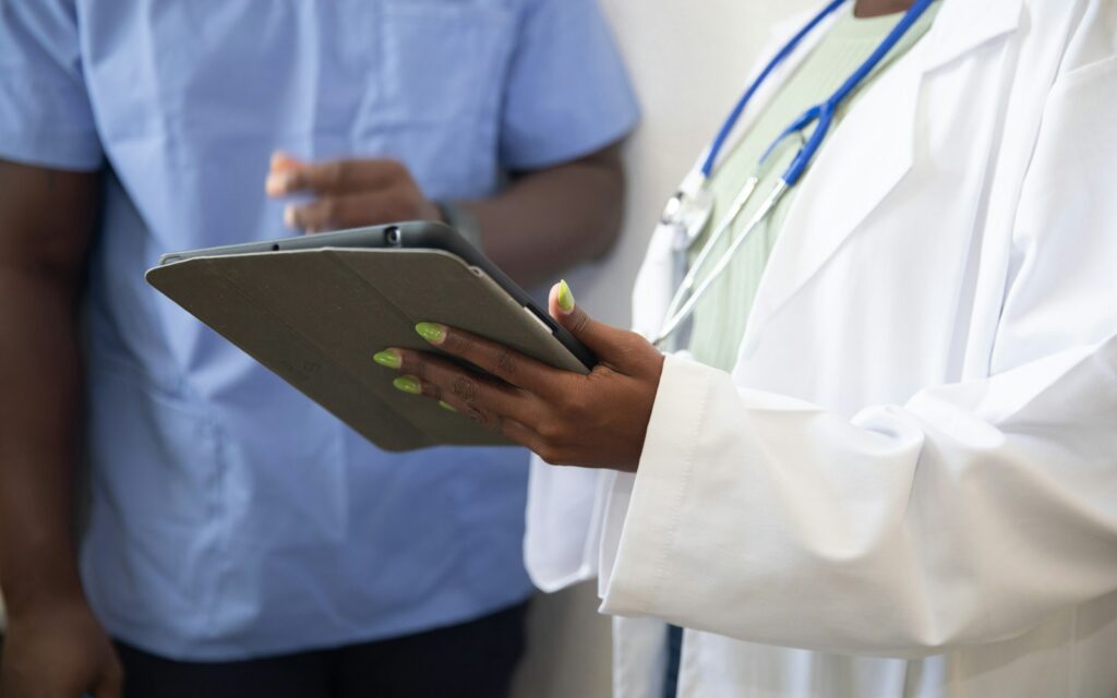 a doctor showing a patient something on the tablet