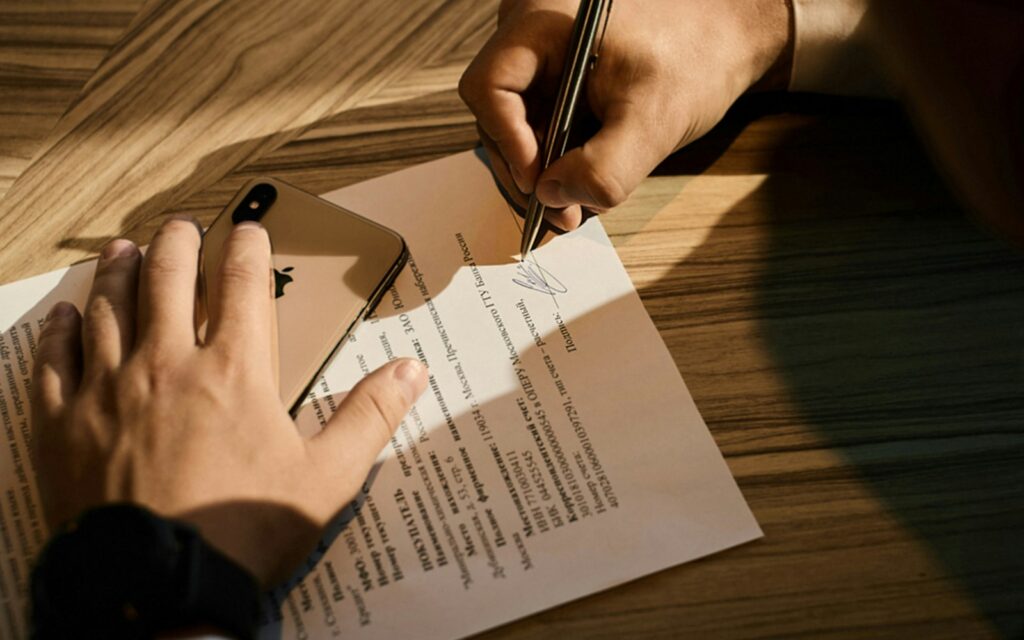 person writing on white paper