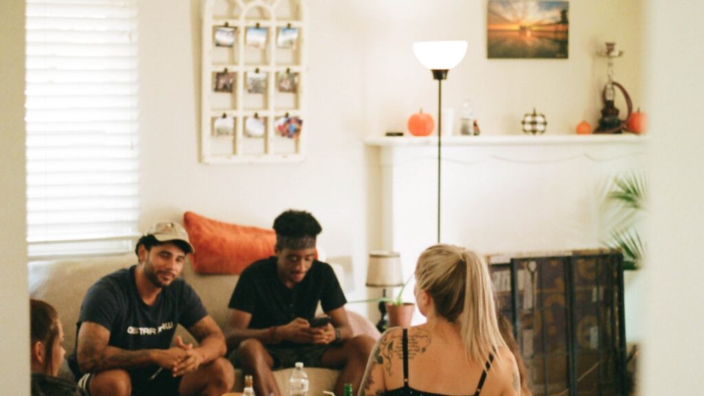 Group of people seated together in a living room during a family intervention
