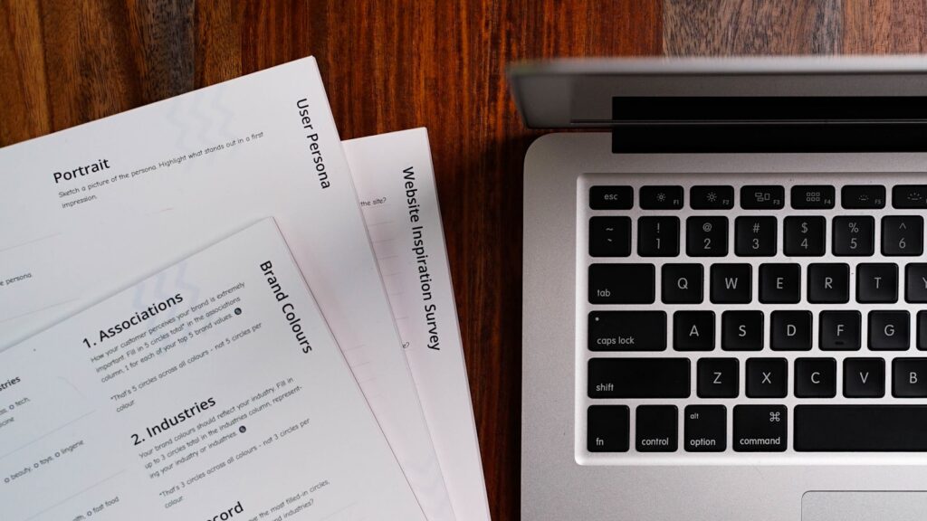Insurance verification paperwork and a laptop on a desk during rehab admissions benefit checks