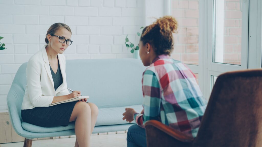 Therapist listening to a patient during a dual diagnosis counseling session