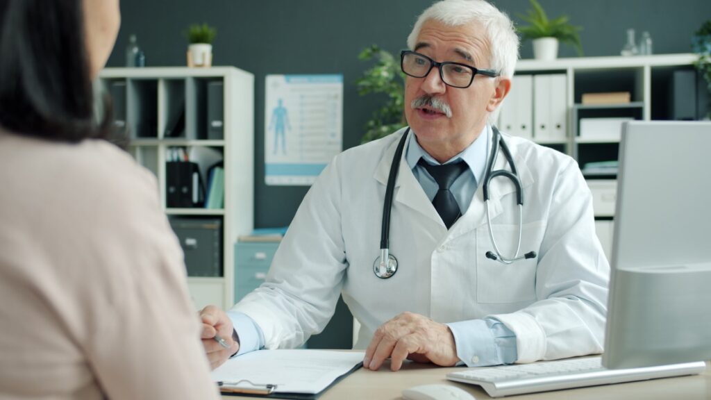 Doctor explaining a diagnosis to a patient in a medical office